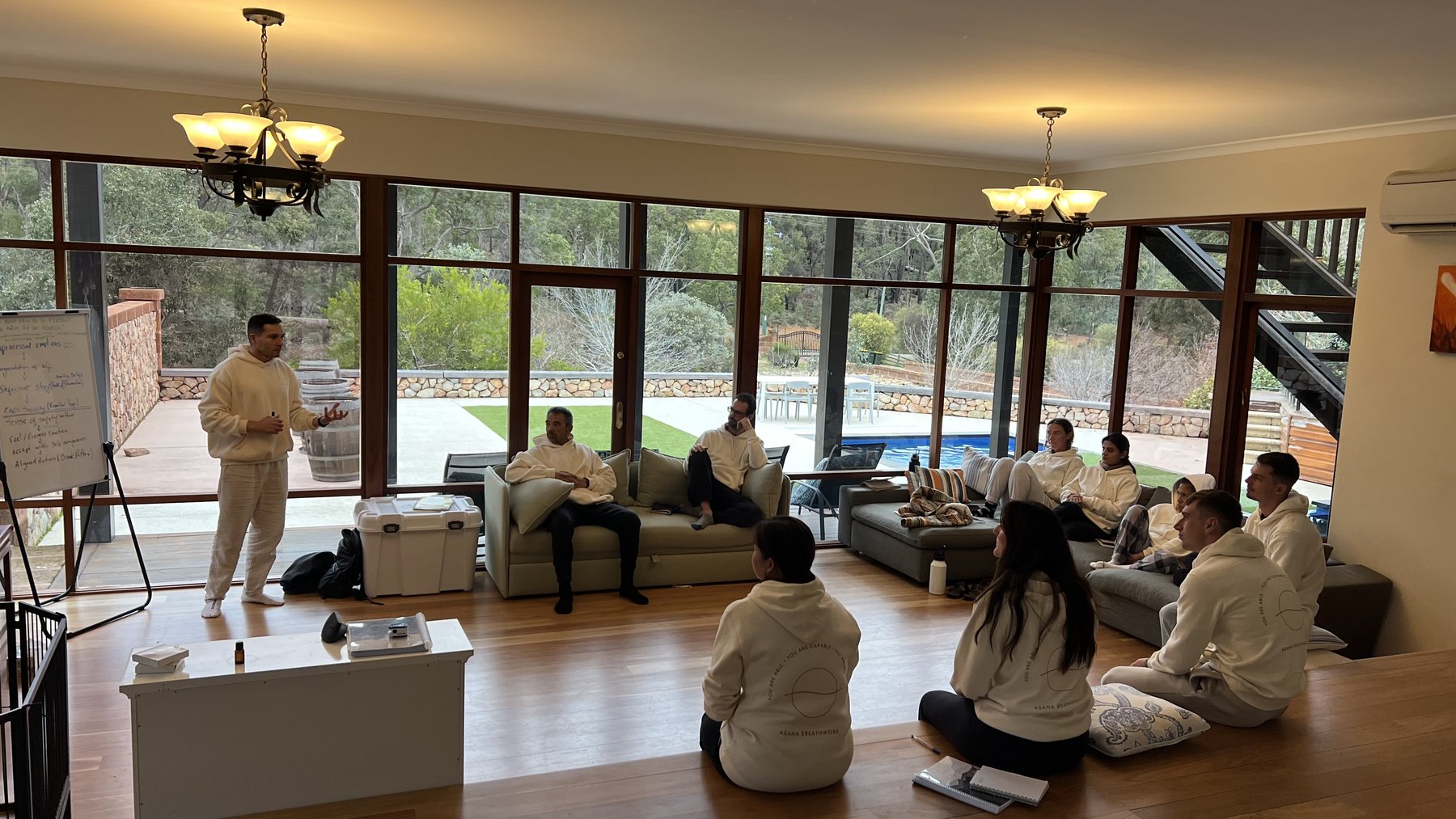 Group learning circle in the retreat living room with bushland views